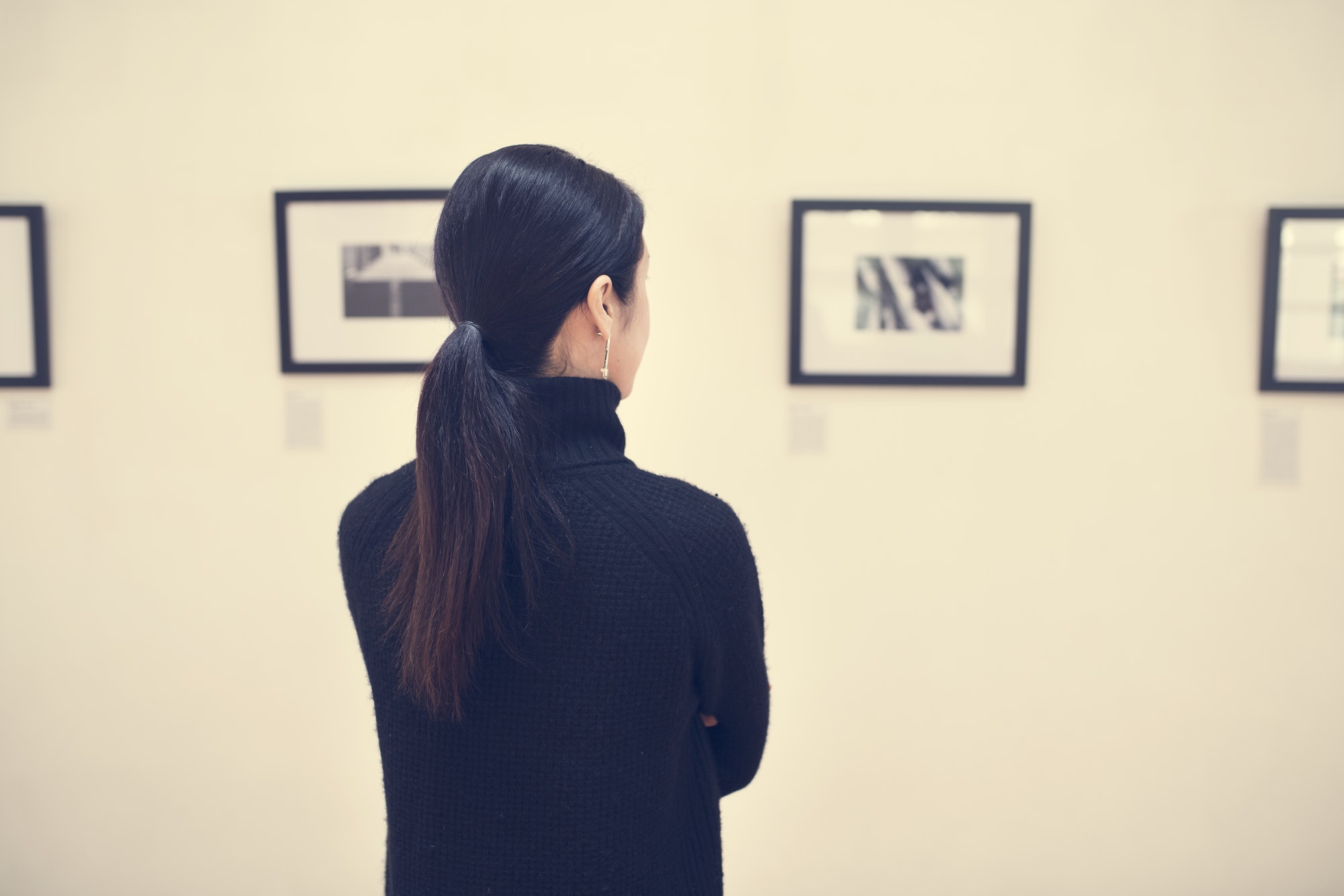 People looking at frames in exhibition